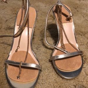 Brown heels with gold chain going around the ankle